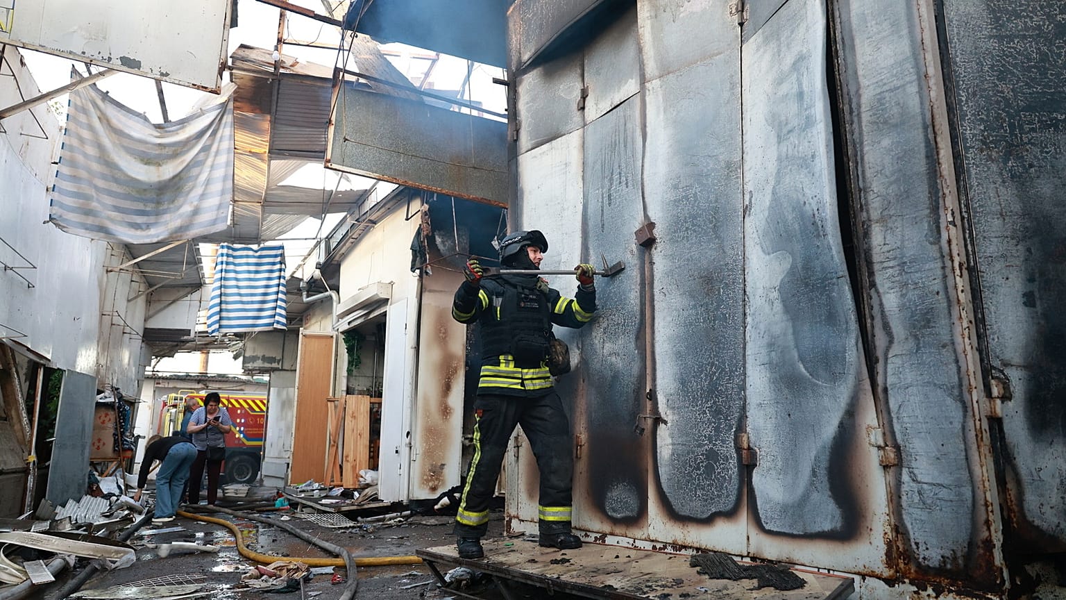 A rescuer works on a site of Russian drone strike on the central market of Zaporizhzhia, Ukraine, on Saturday, Sept. 26, 2026