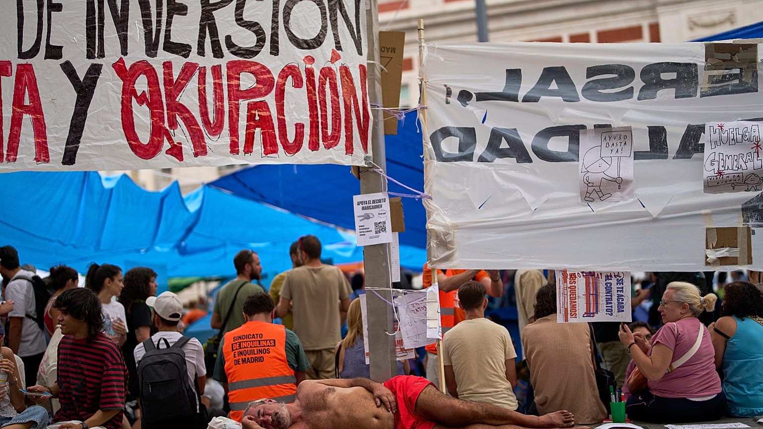 A man sleeps as protesters camp during a protest following the eviction last Wednesday of 87-year-old Maricarmen to demand stronger laws to protect renters.