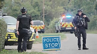 Police stand at a road block on the road to RAF Fairford after an incident in Whelford, 27 September, 2026
