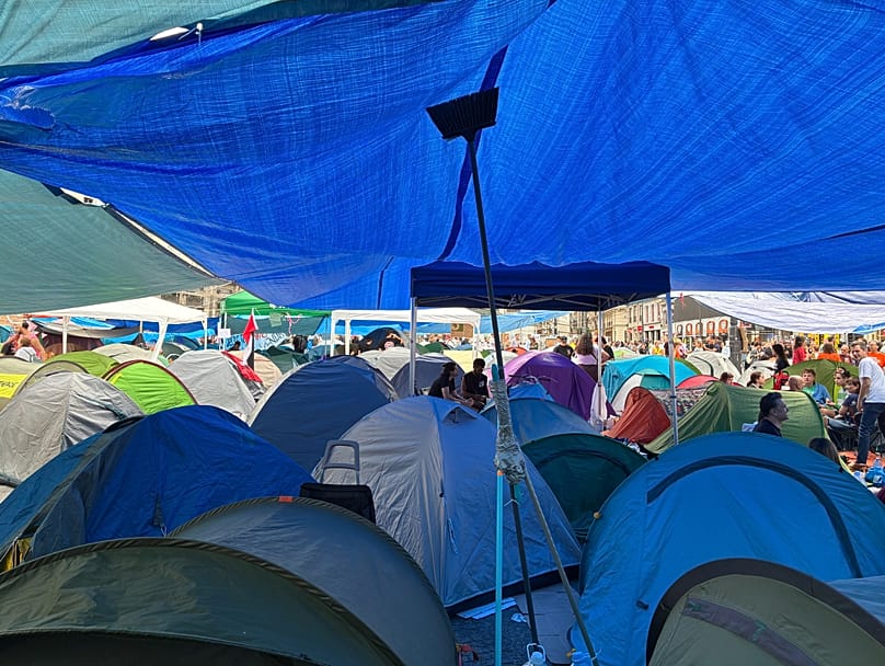 Varias tiendas instaladas bajo toldos protectores en la Puerta del Sol, Madrid, el 28 de septiembre de 2026, durante la acampada por el derecho a la vivienda