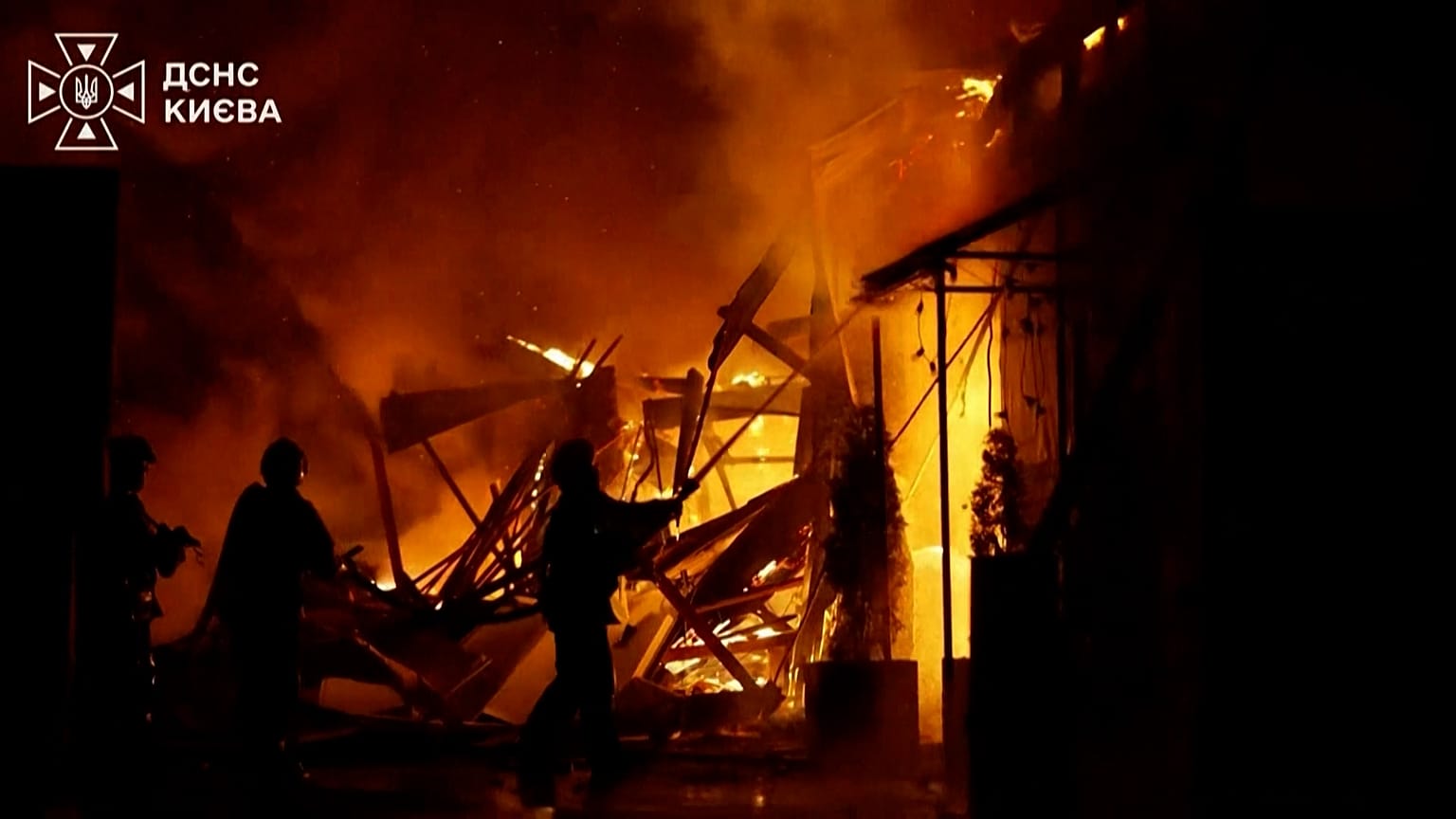 Firefighters are extinguishing a fire after a drone strike in Kyiv