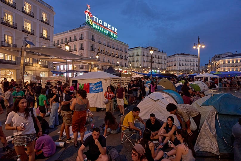 Protesters camp during a protest following the eviction of an 87-year-old woman in Madrid, 27 September, 2026