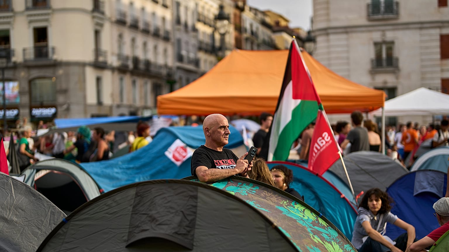 A protester camps during a protest following the eviction last Wednesday of 87-year-old Maricarmen to demand stronger laws to protect renters at Sol square in Madrid