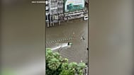 Jet ski rider cruises through flooded streets of Bangkok