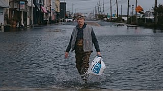 A man walks along a flooded street during a nor'easter storm on Sunday, Sept. 27, 2026, in Sea Bright, NJ, USA.