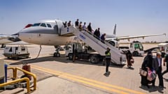 ركاب ينزلون من طائرة إيرانية في مطار النجف بعد انتهاء تعليق الرحلات الجوية الذي نجم عن الحرب الإقليمية التي اندلعت عقب ضربات أمريكية وإسرائيلية استهدفت إيران، وذلك في مدينة ال