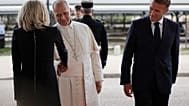 Pope Leo XIV shakes hands with Brigitte Macron, wife of French President Emmanuel Macron, right, during a farewell ceremony at the end of his apostolic trip.