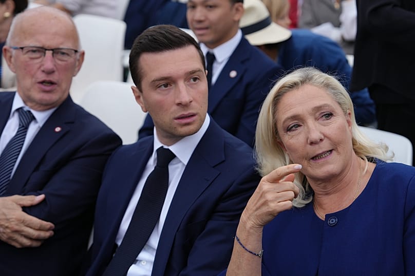 French Far-right leader Marine Le Pen, right, and Jordan Bardella, center, wait for arrival of Pope Leo XIV to celebrate mass at Place de la Concorde, Paris, Sept. 26, 2026