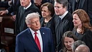 FILE - President Trump walks past US Supreme Court justices as he arrives for his State of the Union address, at the Capitol in Washington, Tuesday, Feb. 24, 2026