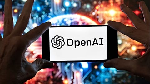 FILE - The OpenAI logo is displayed on a cell phone in front of an image generated by ChatGPT's Dall-E text-to-image model, Dec. 8, 2023, in Boston