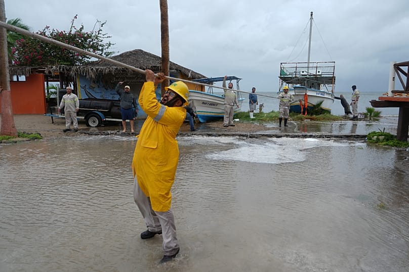 Workers pull a boat to shore as Hurricane Polo approaches Puerto San Carlos, 28 September, 2026