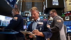File - Trader Robert Charmak works on the floor of the New York Stock Exchange in New York, Friday, 21 Aug. 2026.