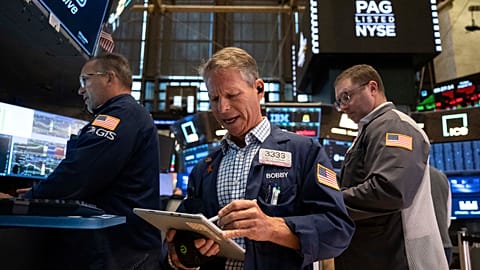 File - Trader Robert Charmak works on the floor of the New York Stock Exchange in New York, Friday, 21 Aug. 2026.