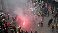 Firefighters light flares during a march in Marseille