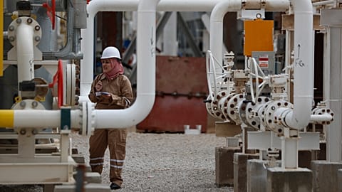 FILE: A woman works at a gas facility in Homs province, 9 November 2022