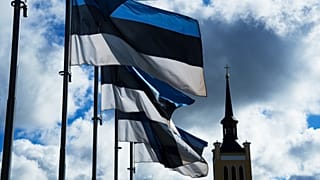 Estonian national flags flutter in the wind at Freedom Square with the St. John's Church in Tallinn, 1 September, 2022
