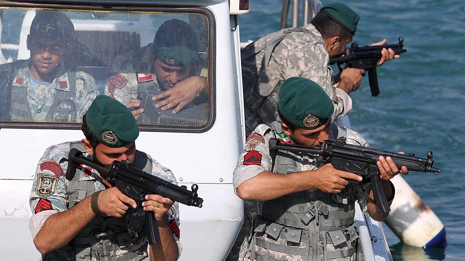 FILE: Iranian navy members take positions during a drill in the Sea of Oman, 28 December 2011