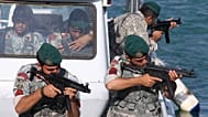 FILE: Iranian navy members take positions during a drill in the Sea of Oman, 28 December 2011
