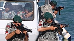 FILE: Iranian navy members take positions during a drill in the Sea of Oman, 28 December 2011
