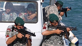 FILE: Iranian navy members take positions during a drill in the Sea of Oman, 28 December 2011