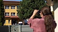 An ambulance parked next to the entrance to the primary school building following a stabbing attack by a pupil in Staskov, 29 September, 2026