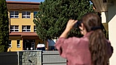 An ambulance parked next to the entrance to the primary school building following a stabbing attack by a pupil in Staskov, 29 September, 2026