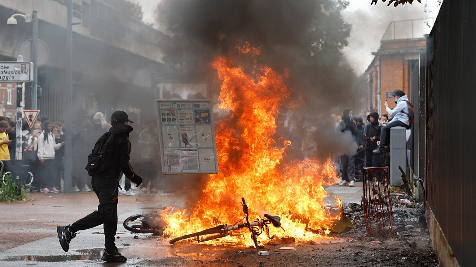 A student walks past a burning bicycle next to the Baggio High School in Lille, 29 September, 2026