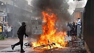 A student walks past a burning bicycle next to the Baggio High School in Lille, 29 September, 2026