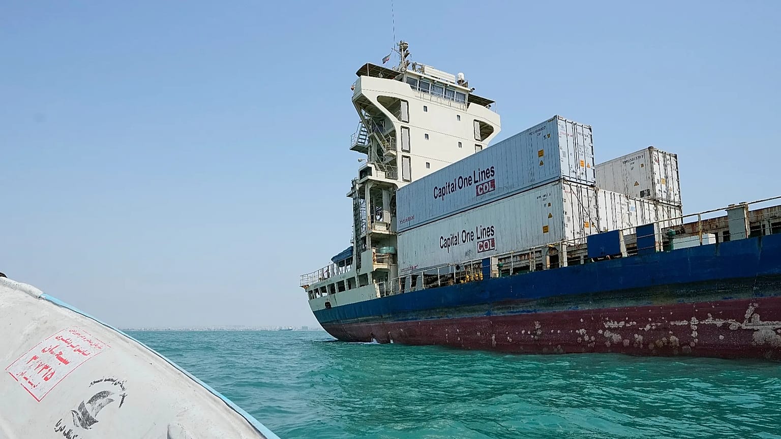 A cargo vessel carrying shipping containers lies anchored in the Strait of Hormuz off Bandar Abbas, Iran, Sunday, Sept. 6, 2026.