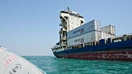 A cargo vessel carrying shipping containers lies anchored in the Strait of Hormuz off Bandar Abbas, Iran, Sunday, Sept. 6, 2026.