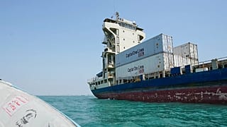 A cargo vessel carrying shipping containers lies anchored in the Strait of Hormuz off Bandar Abbas, Iran, Sunday, Sept. 6, 2026.