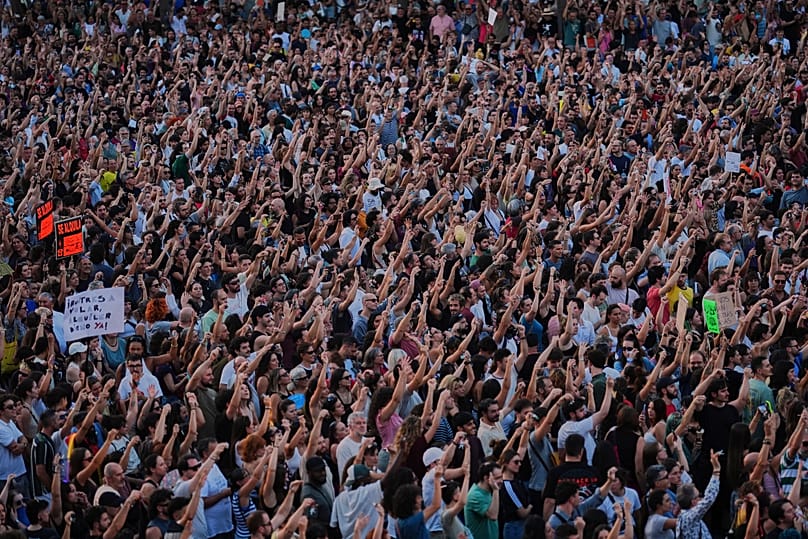 People gather during a protest following the eviction last Wednesday of 87-year-old Maricarmen to demand stronger laws to protect renters at Puerta del Sol in Madrid, Spain.