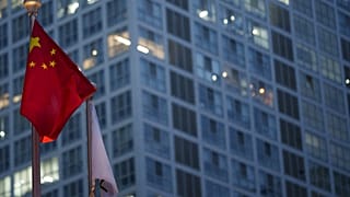 Chinese flag is on display during a ate evening with the background of central business district in Beijing, China, Monday, July 15, 2024.