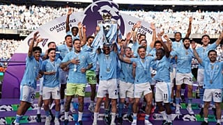 Manchester City players celebrate with the Premier League trophy after the English Premier League soccer match between Manchester City and West Ham United in Manchester.