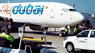 Workers prepare a FlyDubai flight at Dubai International Airport in Dubai, 18 October, 2024