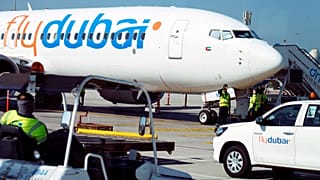 Workers prepare a FlyDubai flight at Dubai International Airport in Dubai, 18 October, 2024
