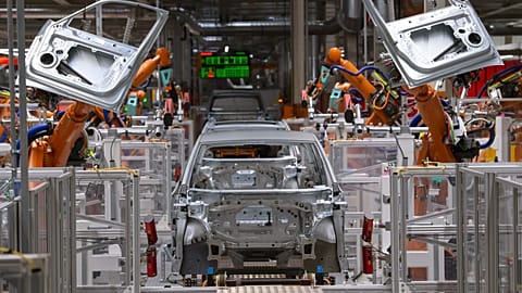 FILE - Robots work on an electric car ID.3 at the assembly line in the plant of the German manufacturer Volkswagen AG (VW) in Zwickau, Germany. 25 February 2020.