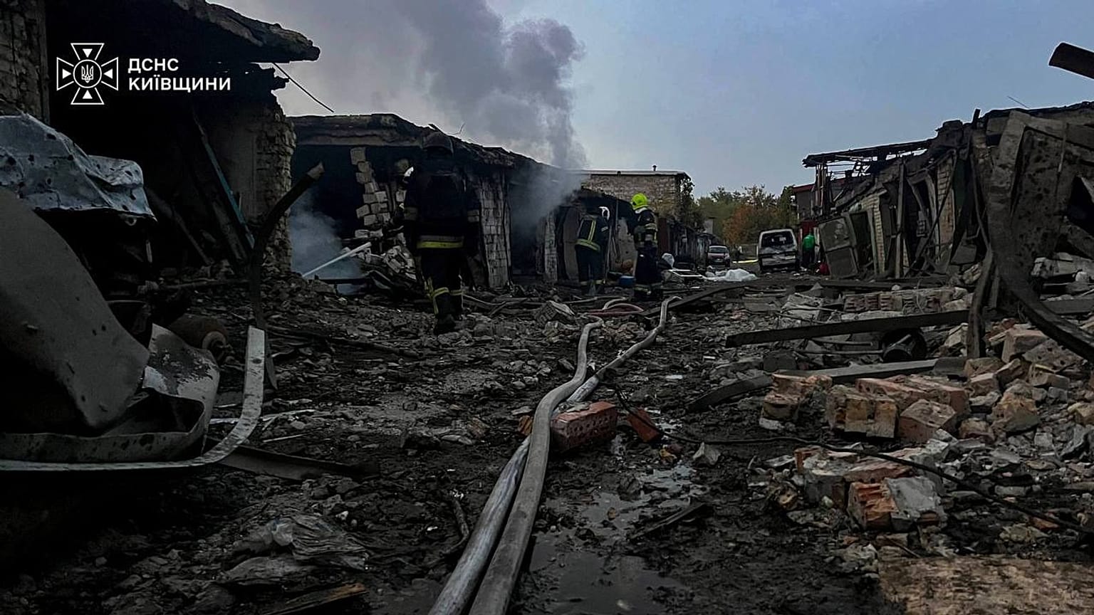 Rescuers put out a fire affecting garages destroyed after a Russian drone strike on Kyiv region, 30 September, 2026