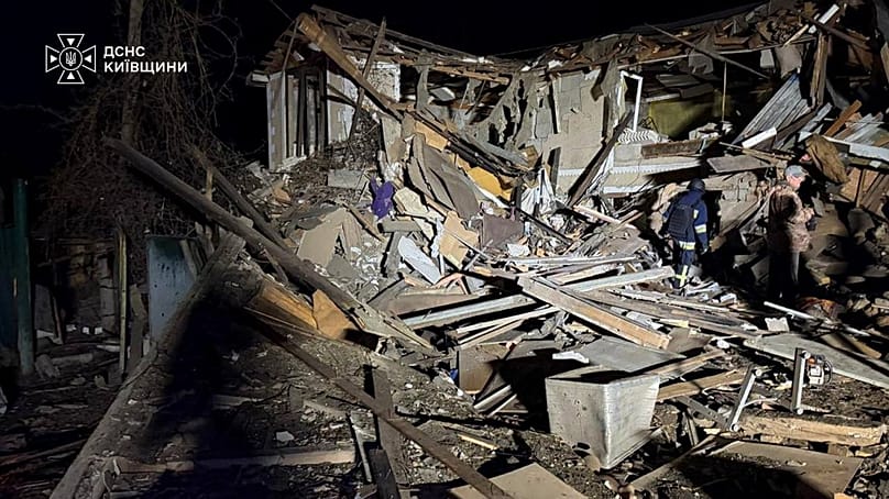 A rescuer walks on a site of a Russian drone strike on residential house in Kyiv region, 30 September, 2026