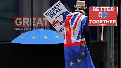 Pro-EU demonstrator Steve Bray props banners outside the conference centre in Westminster where trade talks between the UK and the EU continue in London, Friday, Dec. 4, 2020 