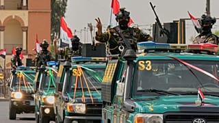Iraqi security officers flash victory signs as they ride on vehicles during a convoy celebrating the full withdrawal of US troops, in Baghdad, Iraq, Wednesday, Sept. 30, 2026