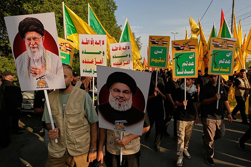 Iraqis carry portraits of slain Iranian leader Ali Khamenei, Hezbollah leader Hassan Nasrallah during rally marking US withdrawal from Iraq, Baghdad, Wednesday, Sept. 30, 2026