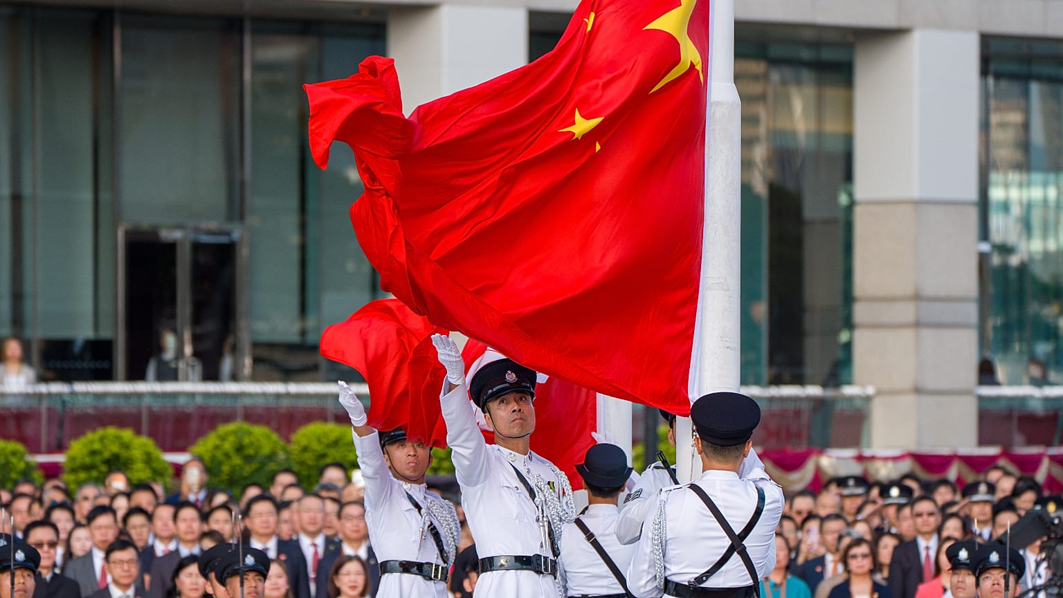 Police guard raises Chinese and Hong Kong flags for National Day in Hong Kong, Thursday, Oct. 1, 2026.