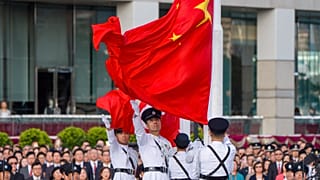 Police guard raises Chinese and Hong Kong flags for National Day in Hong Kong, Thursday, Oct. 1, 2026.