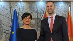 European Commissioner for Enlargement Marta Kos, left, shakes hands with Montenegro Prime Minister Milojko Spajic in Podgorica, Montenegro, Thursday, March 26, 2026.
