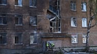 Police officers carry an unexploded warhead from a Shahed drone out of a school damaged by a Russian strike on Kyiv, 1 October, 2026