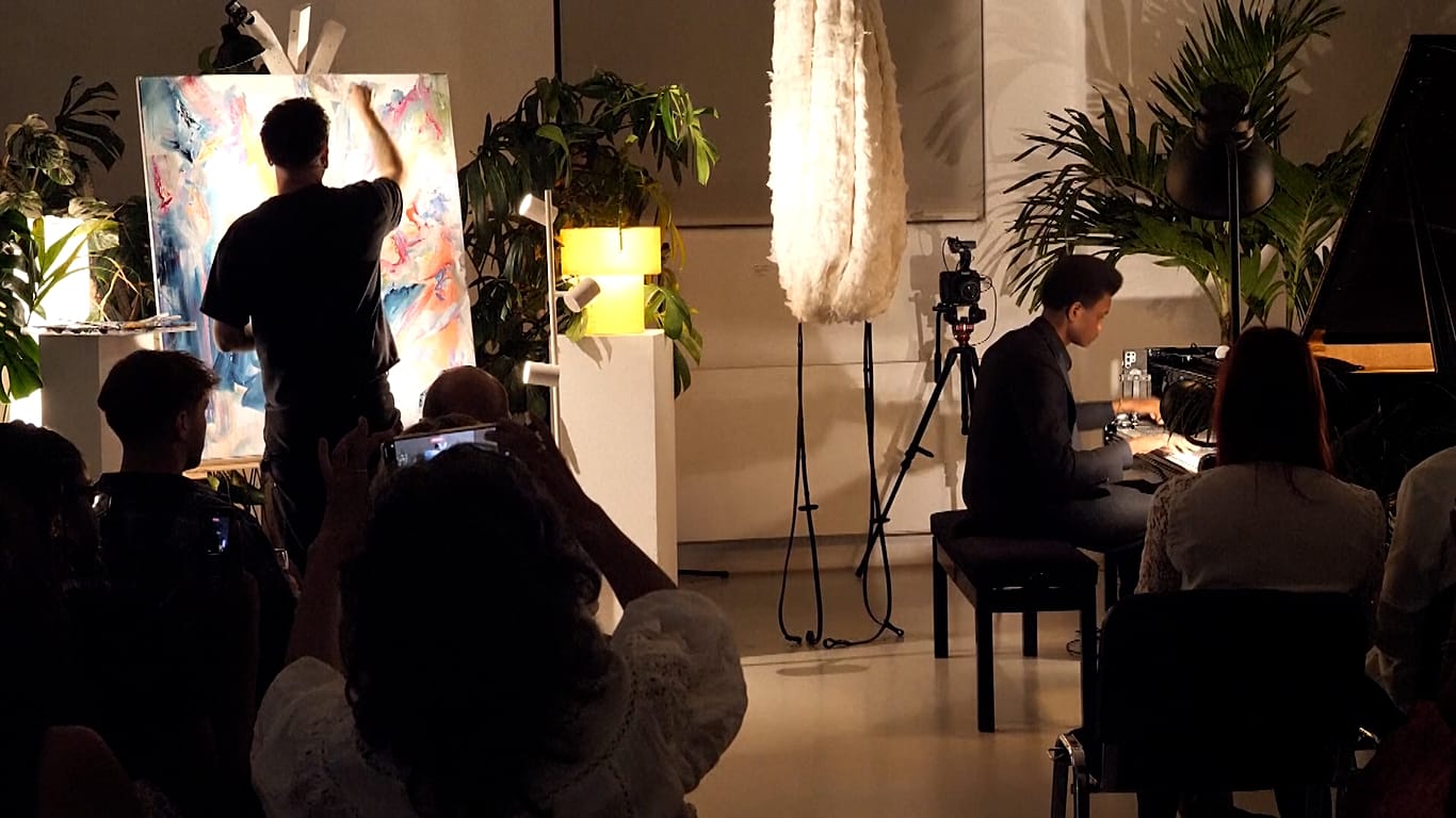 Jake Andrew painting to the music he sees during a performance at the Handbag Factory in Vauxhall, London, UK.