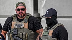 Immigration and Customs Enforcement officers stand at the scene where a man was shot in his vehicle by an ICE officer, Sunday, Sept. 20, 2026, in Austin, Texas