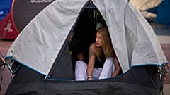 Woman wakes after camping overnight at Barcelona rent protest, Sept. 30, 2026.