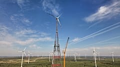 A newly constructed wind turbine, whose rotor tips reach a maximum height of 365 meters (1,198 feet), stands in Schipkau, Germany, Thursday, Oct. 1, 2026